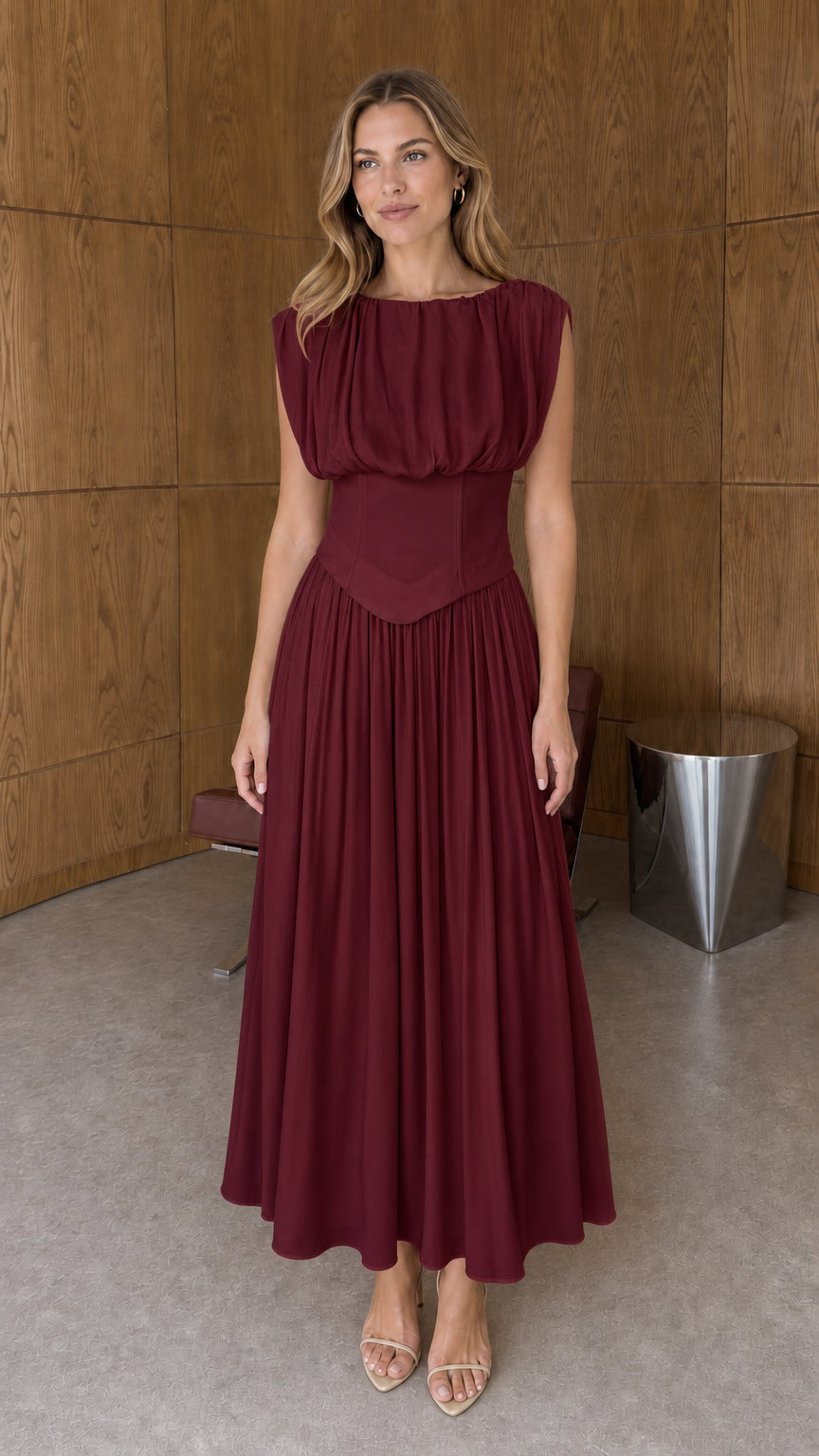 Full-length front view of burgundy red sleeveless basque waist pleated midi dress