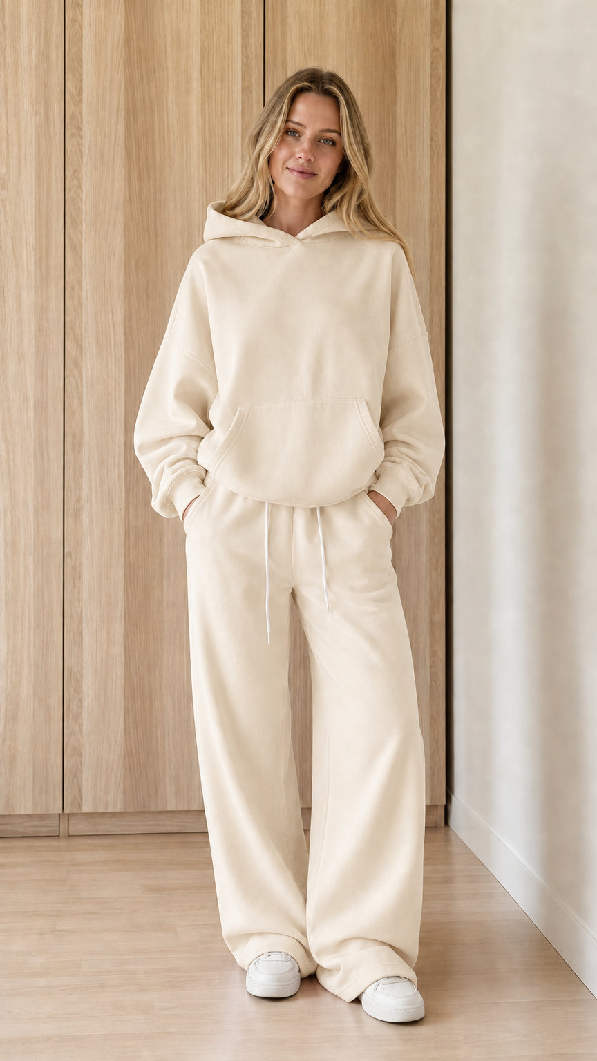 Model wearing a cream women's hoodie and wide-leg sweatpants set