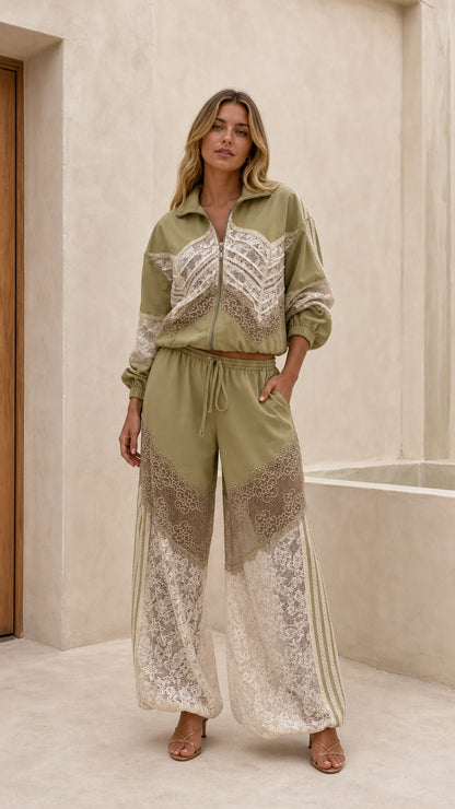 Front view of woman wearing sage green lace patchwork track jacket and wide leg pants set