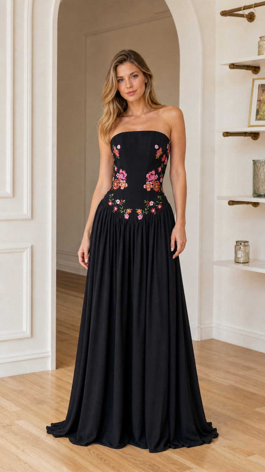 Front view of woman wearing black floral embroidered strapless maxi dress