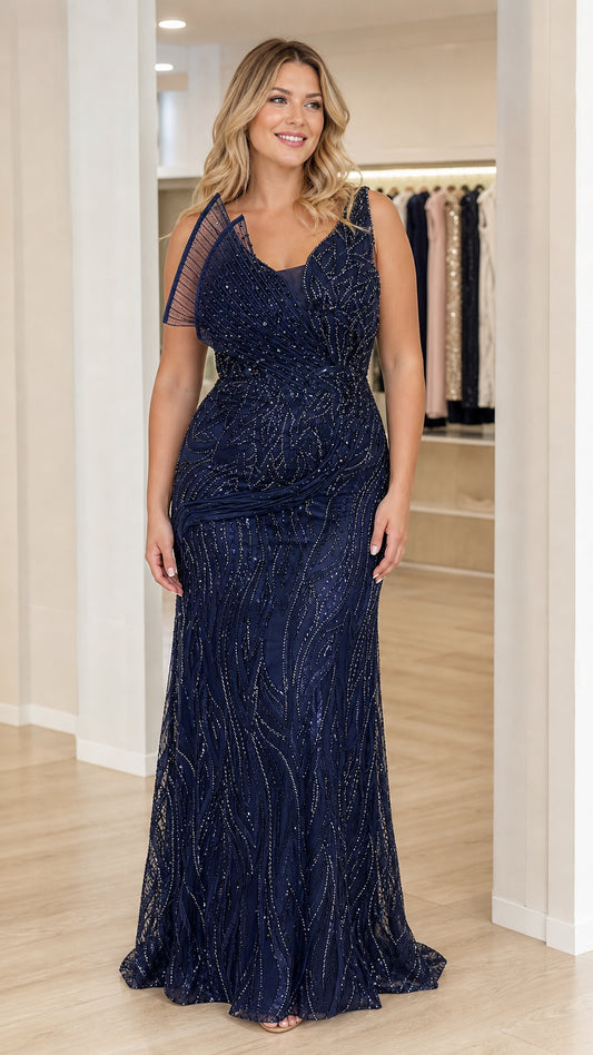 Full front view of navy blue beaded evening gown with pleated shoulder accent