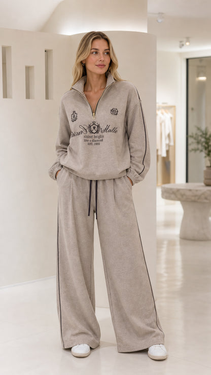 Woman wearing the taupe quarter-zip wide-leg tracksuit set from the front