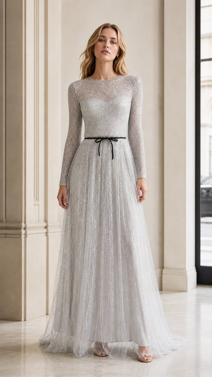 Front view of model wearing silver long-sleeve sequin tulle evening gown