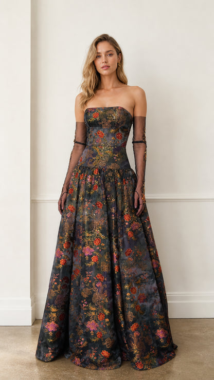 Front view of charcoal floral strapless evening gown with sheer sleeves