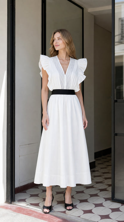 Front view of woman wearing white ruffle V-neck midi dress with black waist tie