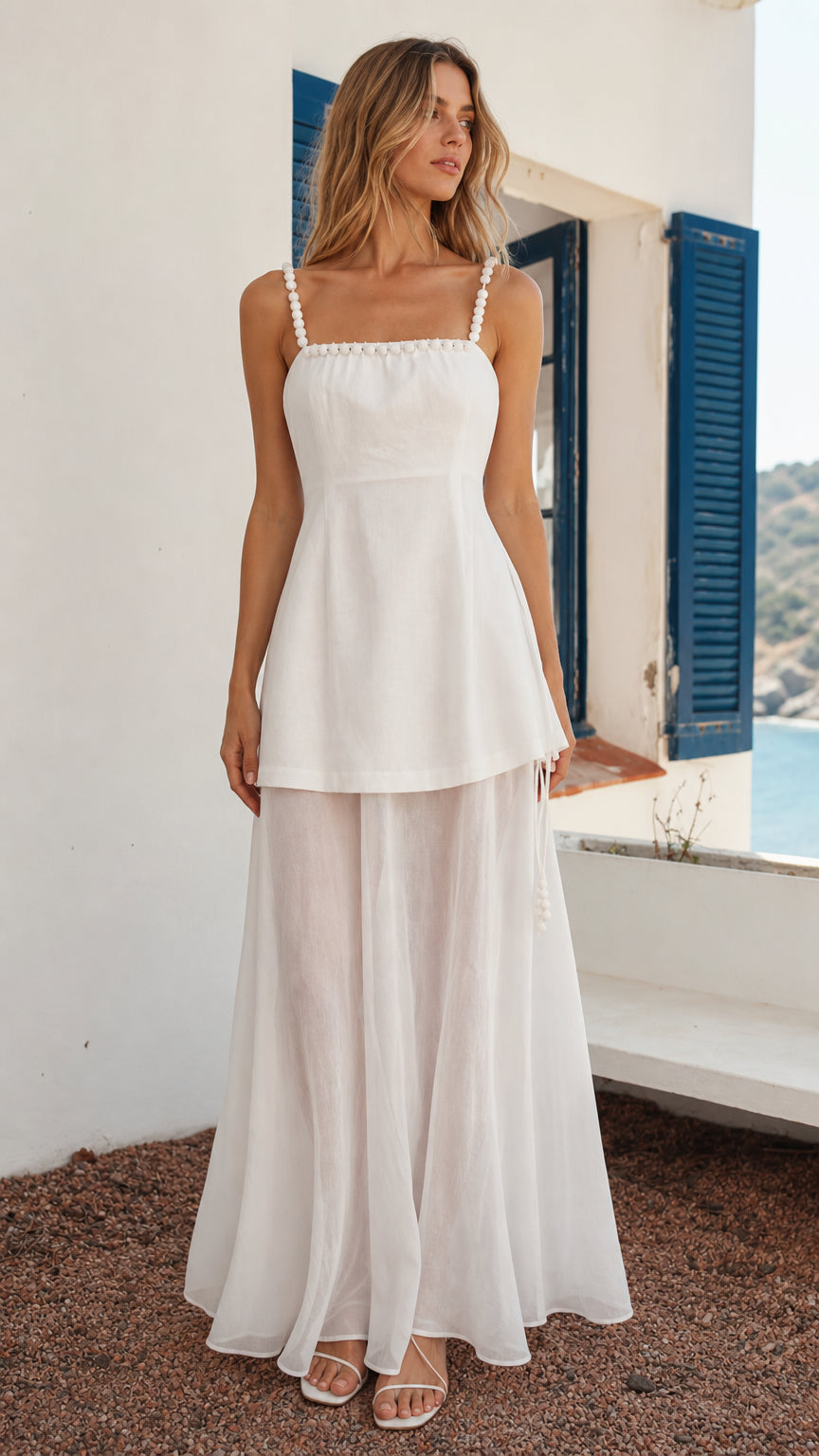 Front view of woman wearing white beaded strap layered maxi dress