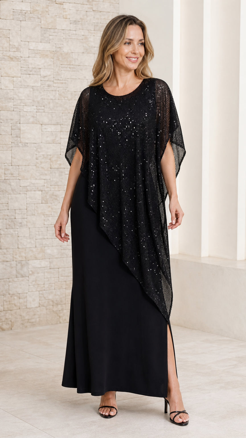 Front view of model wearing black maxi evening dress with asymmetrical black sequin capelet overlay