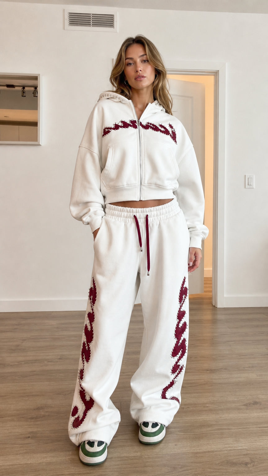 Full front view of model wearing white cropped zip hoodie and wide leg sweatpants tracksuit set