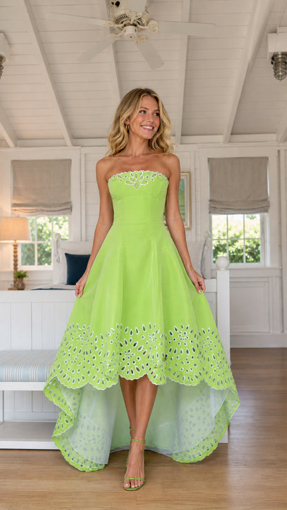 Model wearing lime green strapless high-low party dress, front view