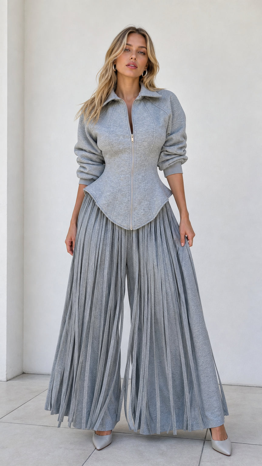 Front view of model wearing heather grey zip corset top and matching pleated wide-leg pants set