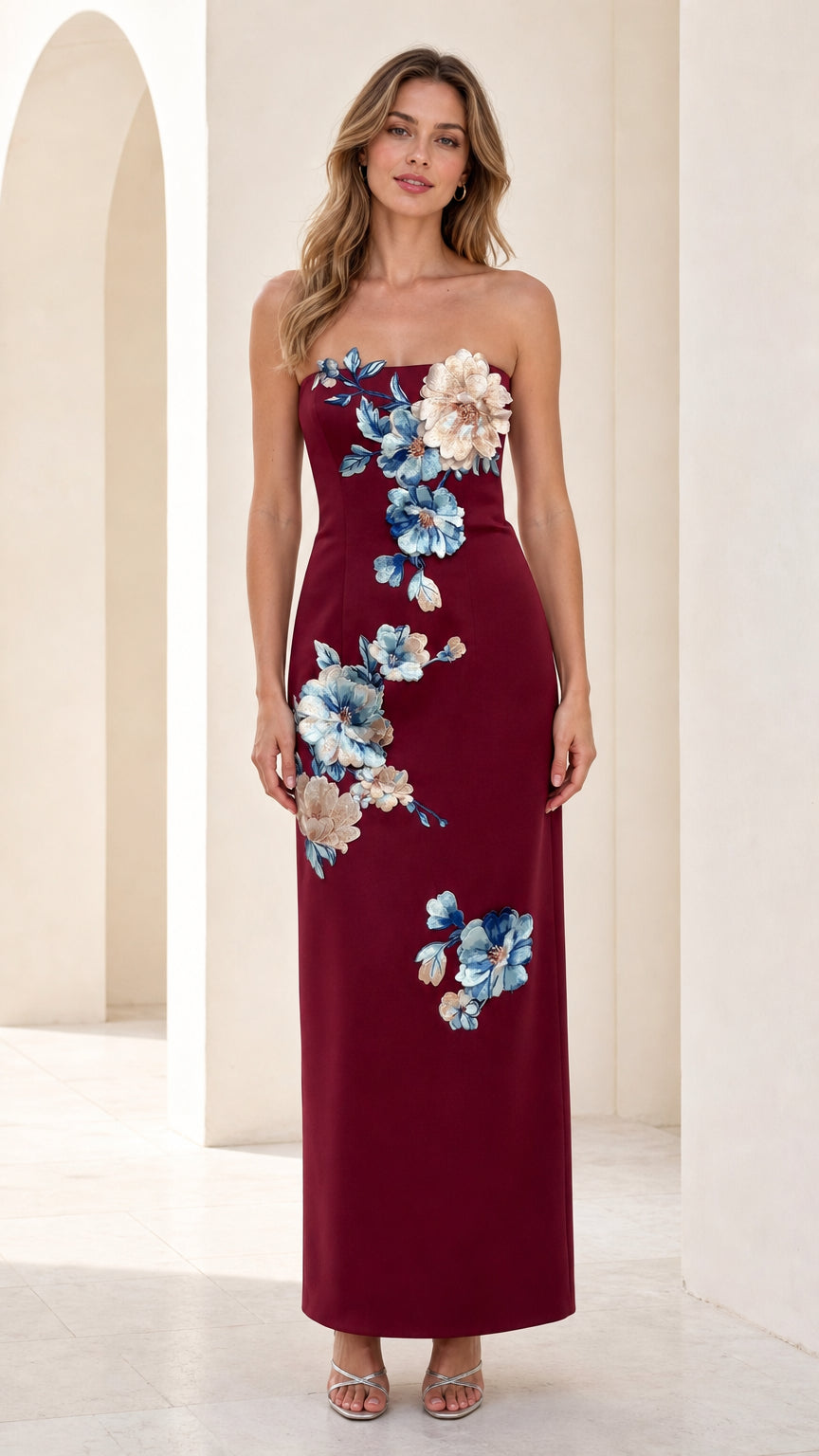 Front view of burgundy strapless maxi dress with 3d floral appliques