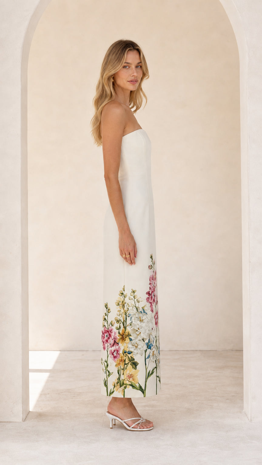 Model wearing white floral strapless midi maxi dress from the side profile