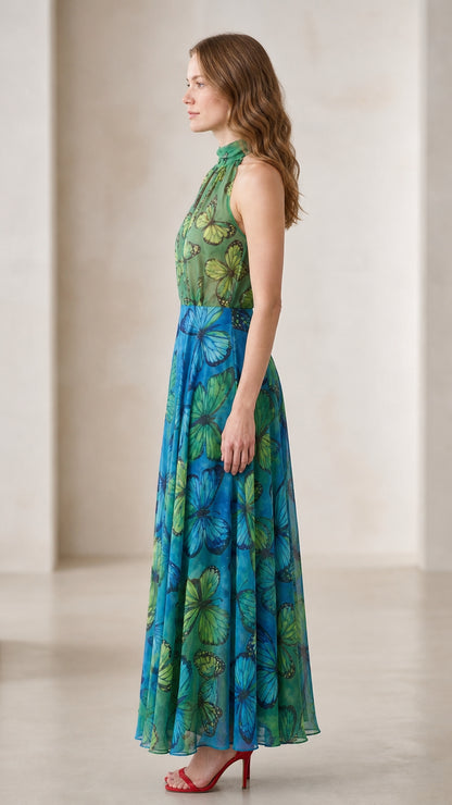 Side profile view of woman modeling emerald blue butterfly print maxi dress