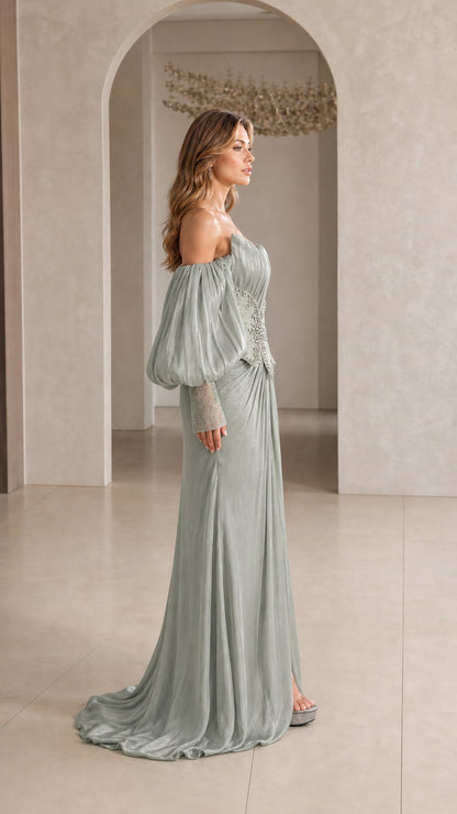 Side profile view of Sage Green pleated formal gown with statement puff sleeves