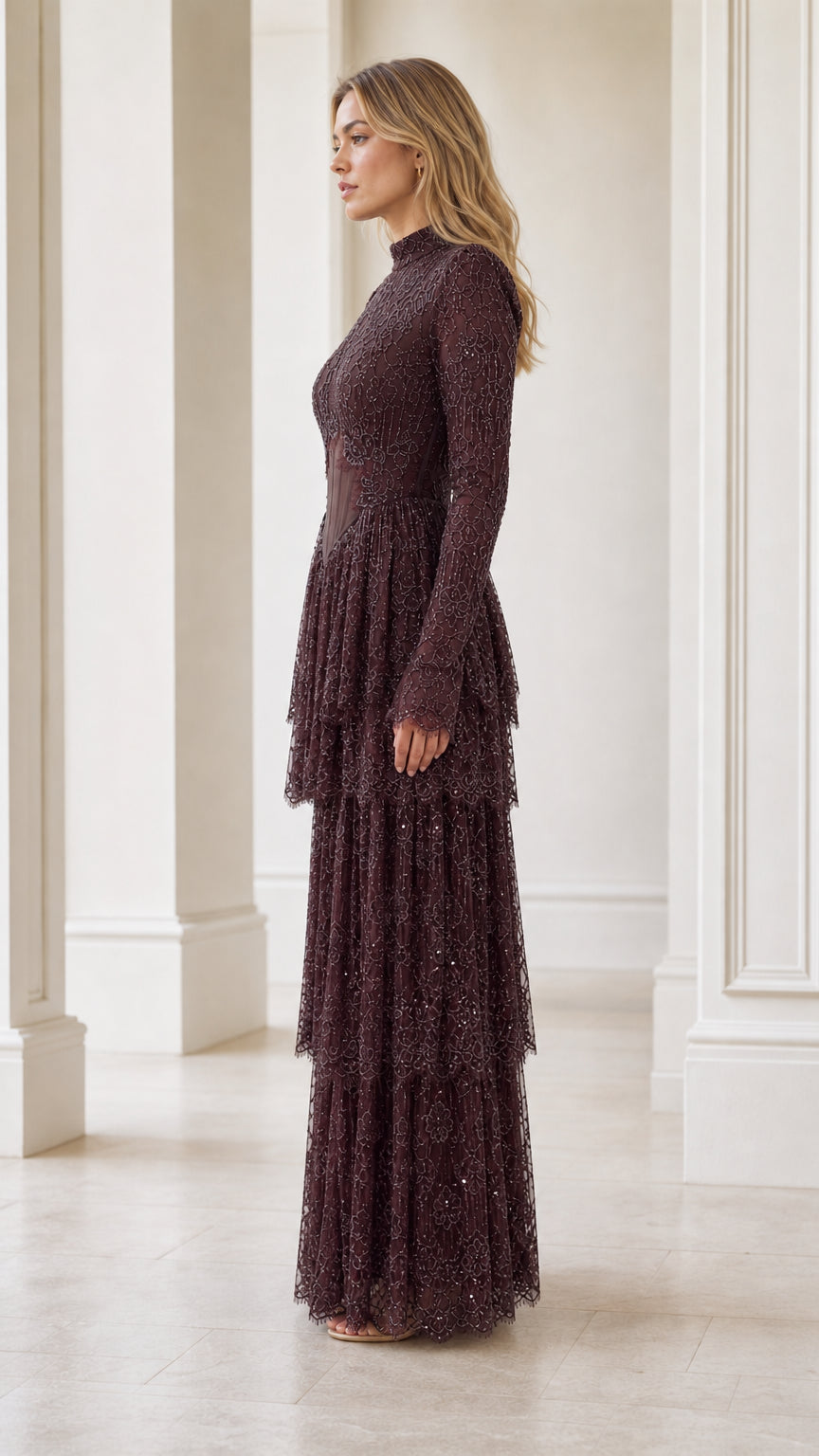 Side profile view of burgundy beaded tiered formal dress
