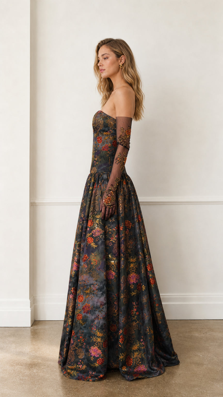 Side profile view of charcoal floral gown showing silhouette and sleeve details