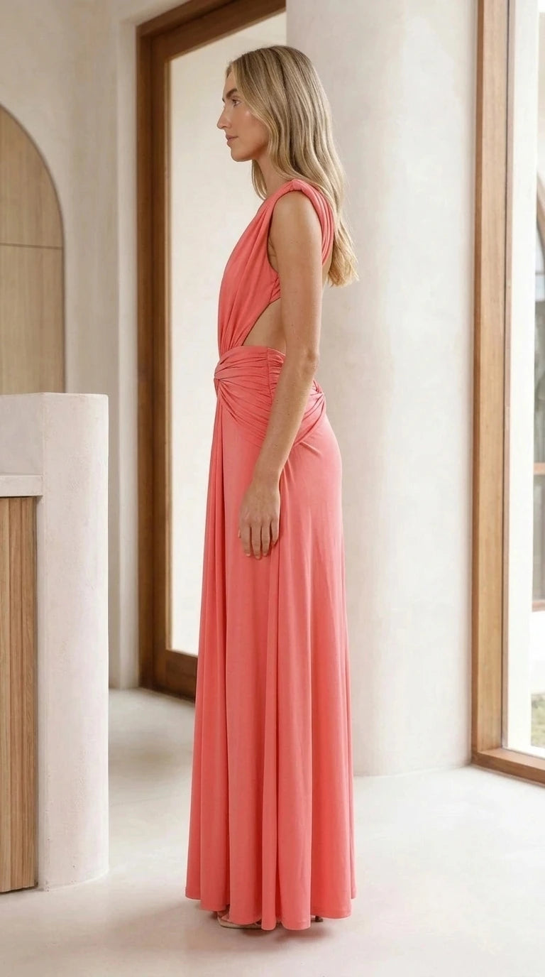 Side view of model showing cutout and drape of coral maxi gown
