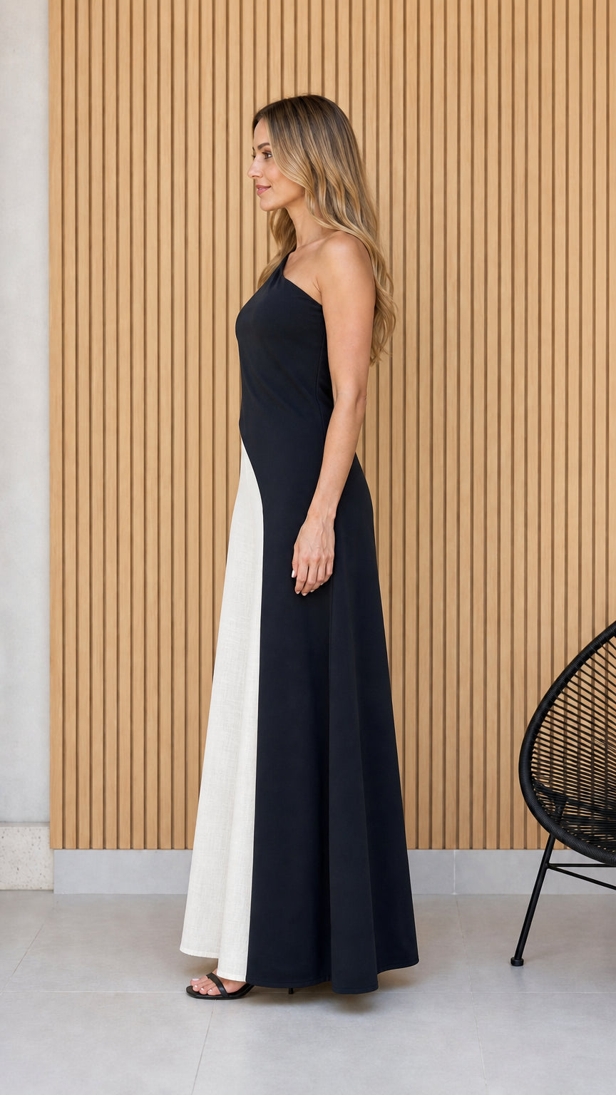 Side profile view of black and white one-shoulder jumpsuit