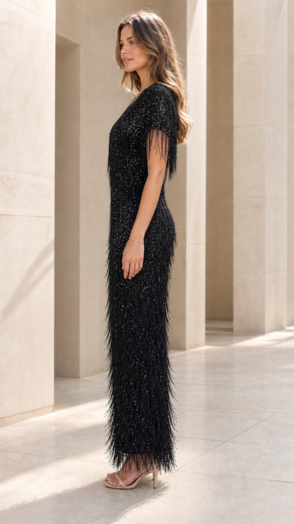 Side profile view of black sequin fringe long dress