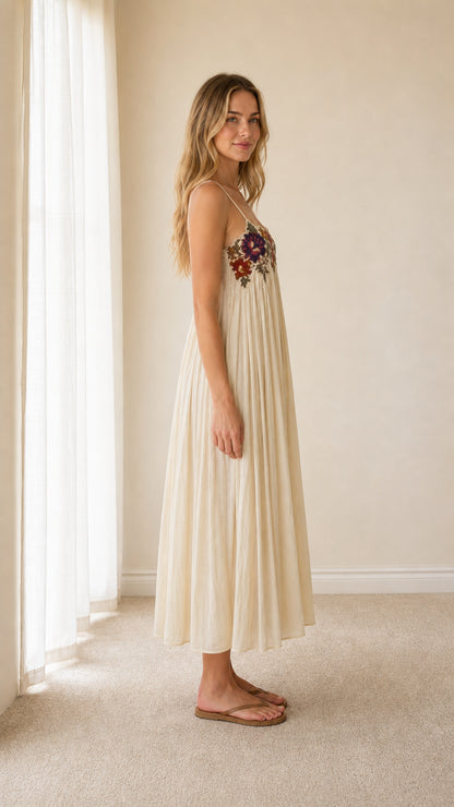Side view of cream embroidered camisole dress on model
