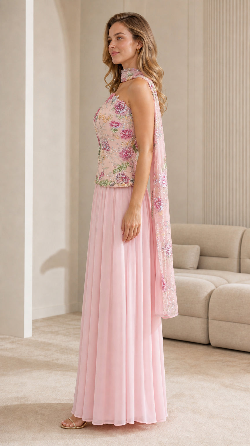 Side profile view of pink embroidered strapless maxi dress