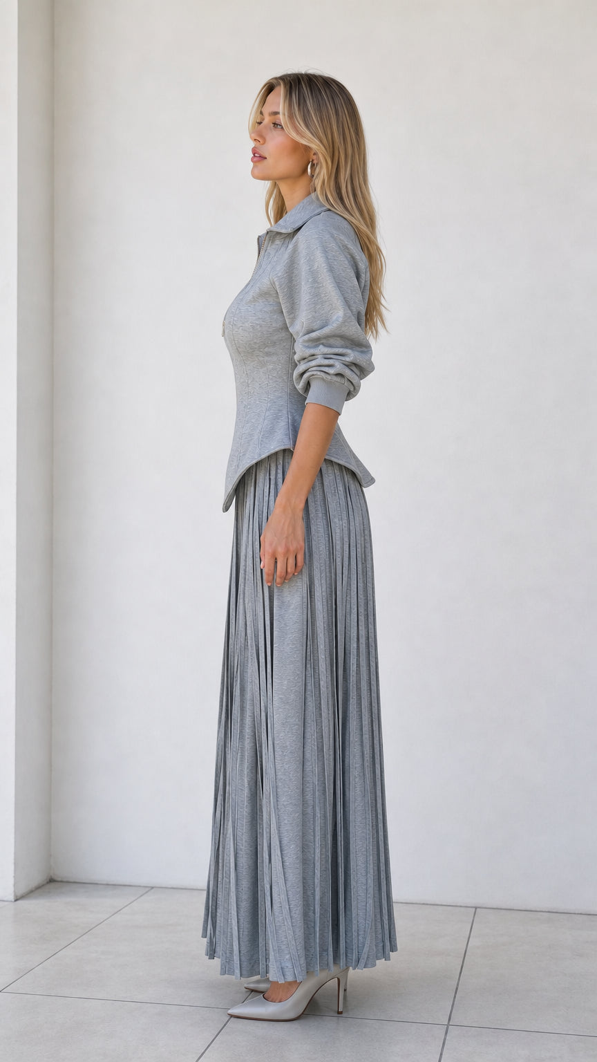 Side profile of model wearing heather grey two-piece knit matching set