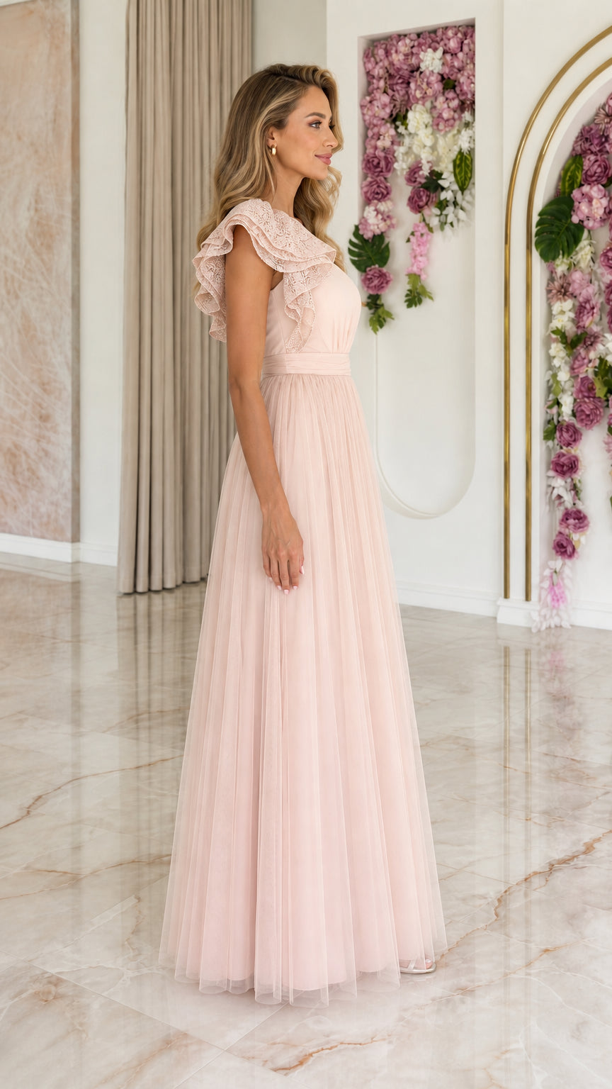 Side profile view of blush pink one-shoulder tulle evening dress