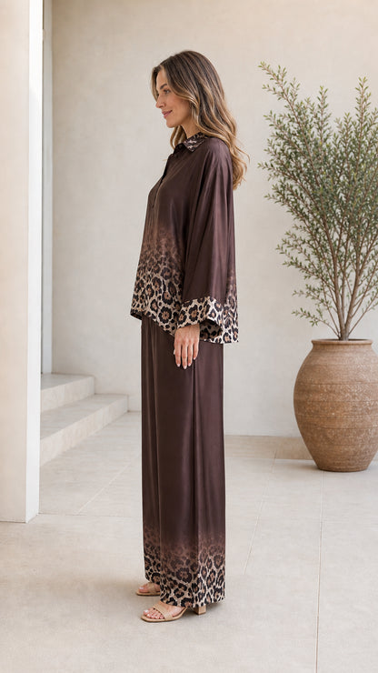 Side profile view of woman in brown satin two-piece set
