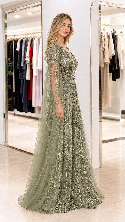 Side profile of sage green formal gown showing sheer flowing cape sleeves