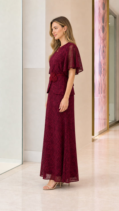 Side profile of model in burgundy lace gown