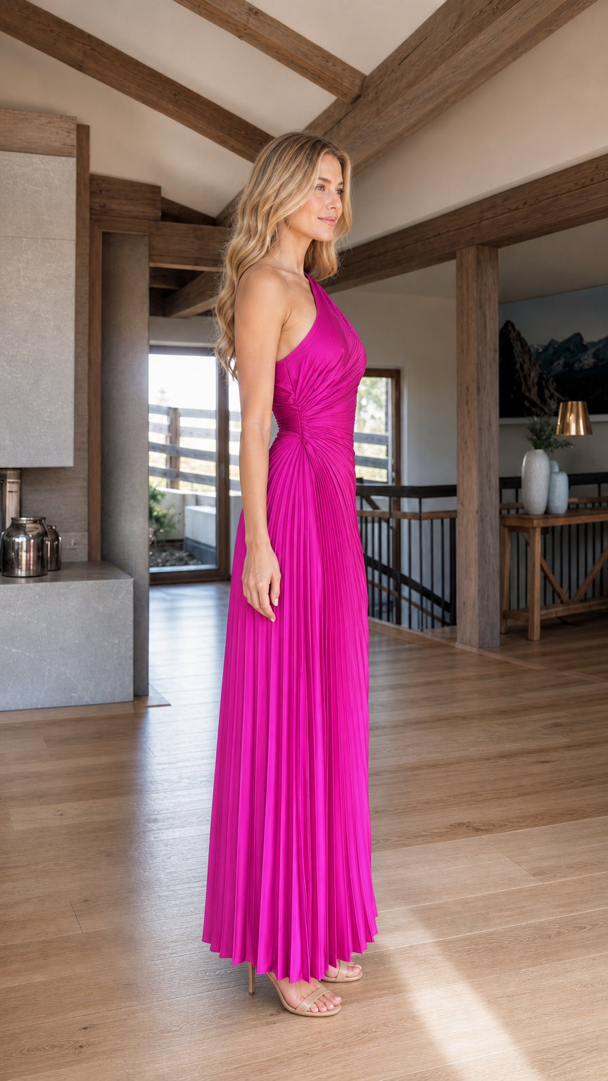 Side profile view of fuchsia pleated evening gown