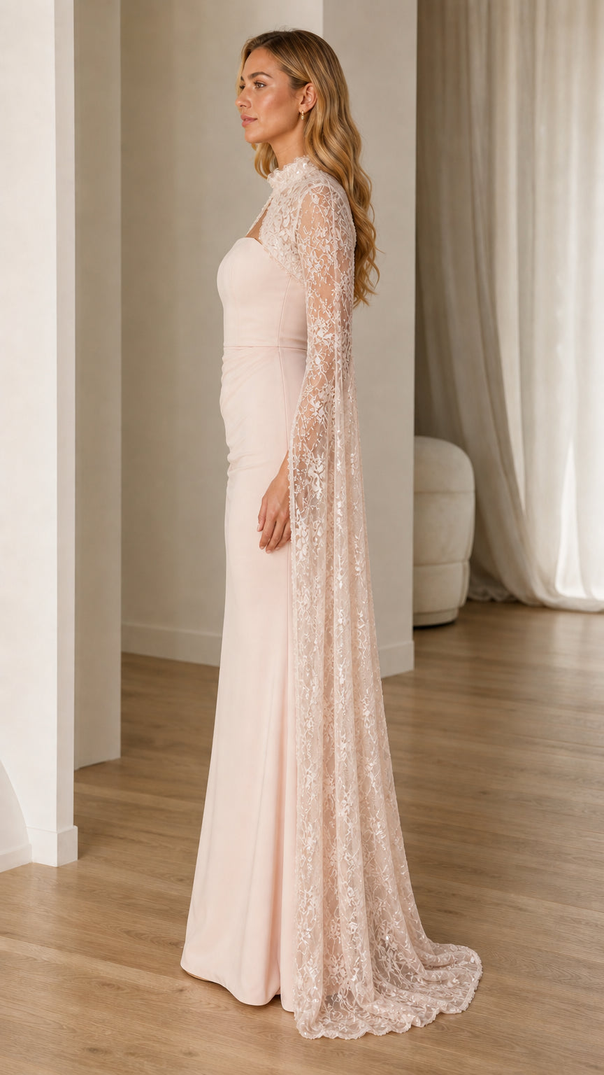 Side profile of blush pink evening gown with floor-sweeping cape