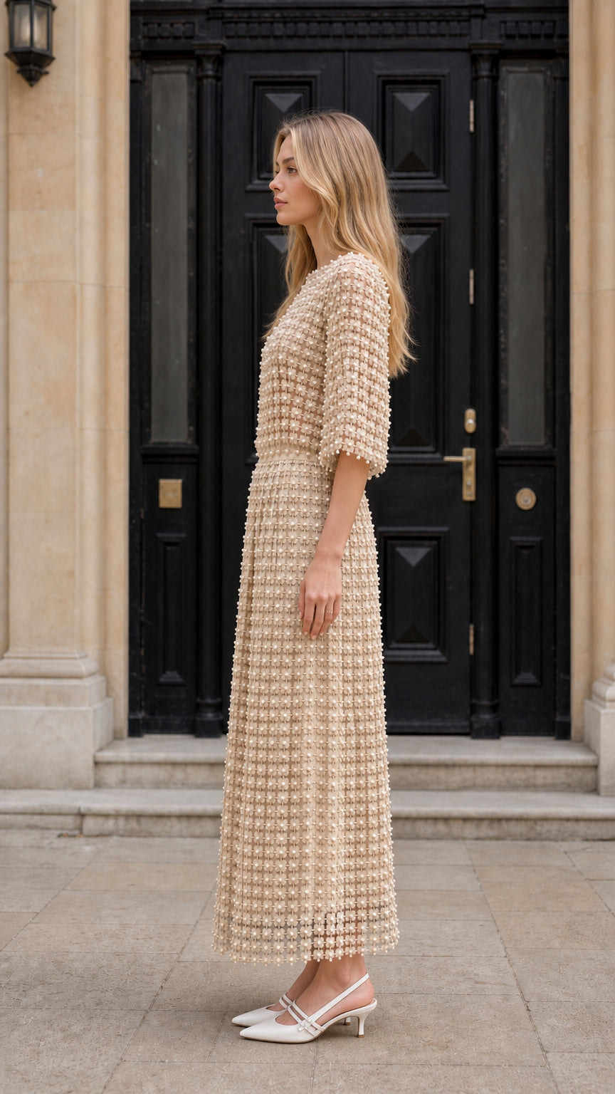 Side view of model wearing beige textured midi dress