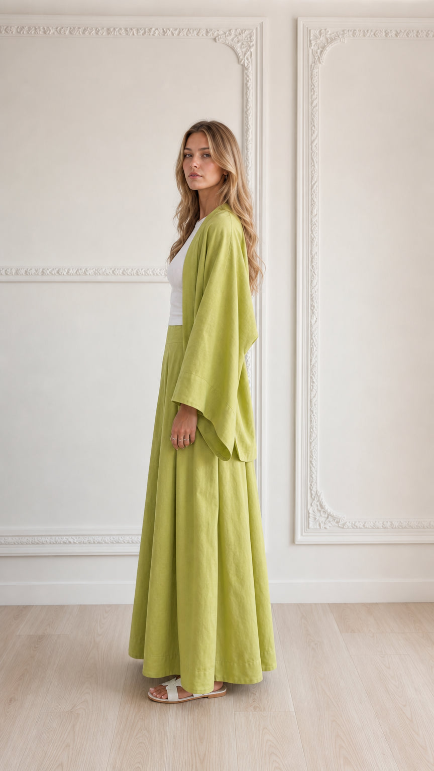 Side profile of woman in lime green 2-piece wide sleeve cardigan and pant set