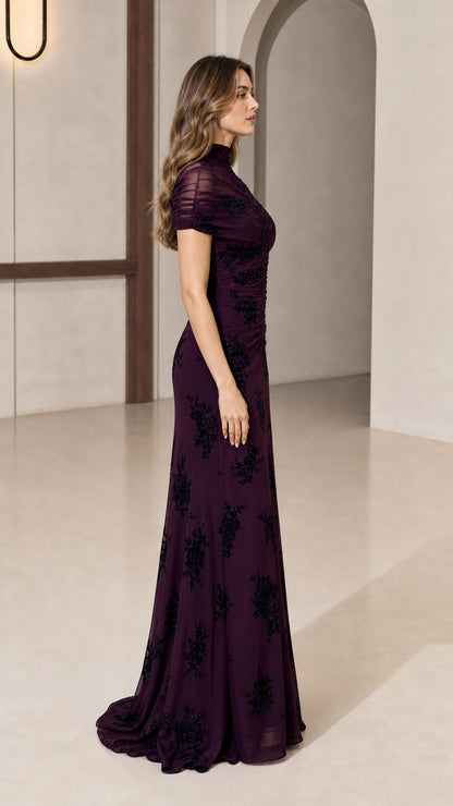 Model wearing plum evening gown side profile view