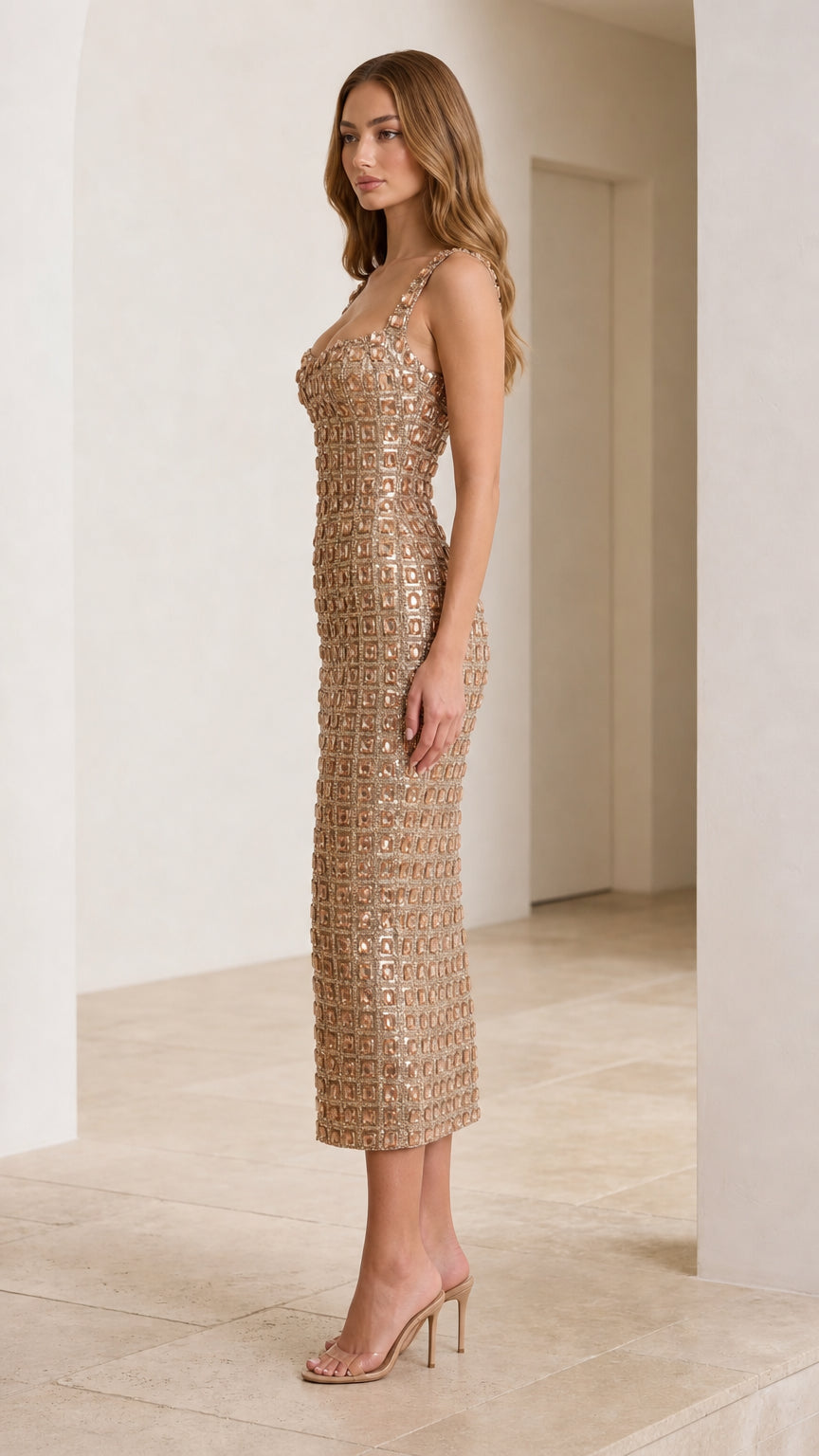 Side profile of model in champagne rhinestone dress