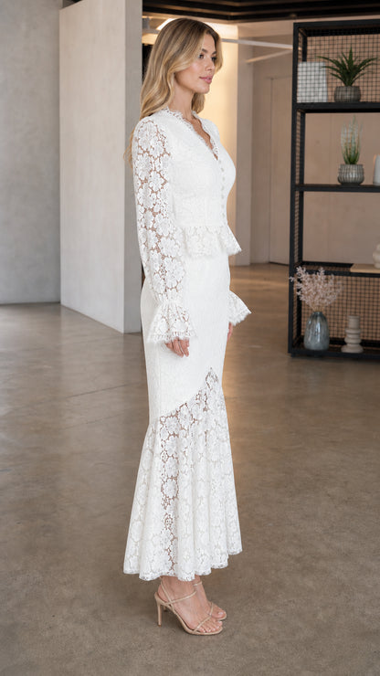 Side profile of model in white lace dress