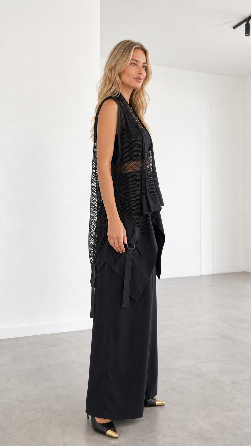 Model wearing black two-piece set side profile view
