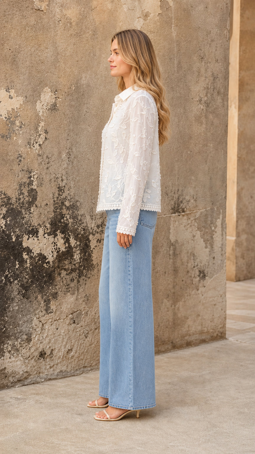 Side view of white floral embroidered blouse with long sleeves and pointed collar
