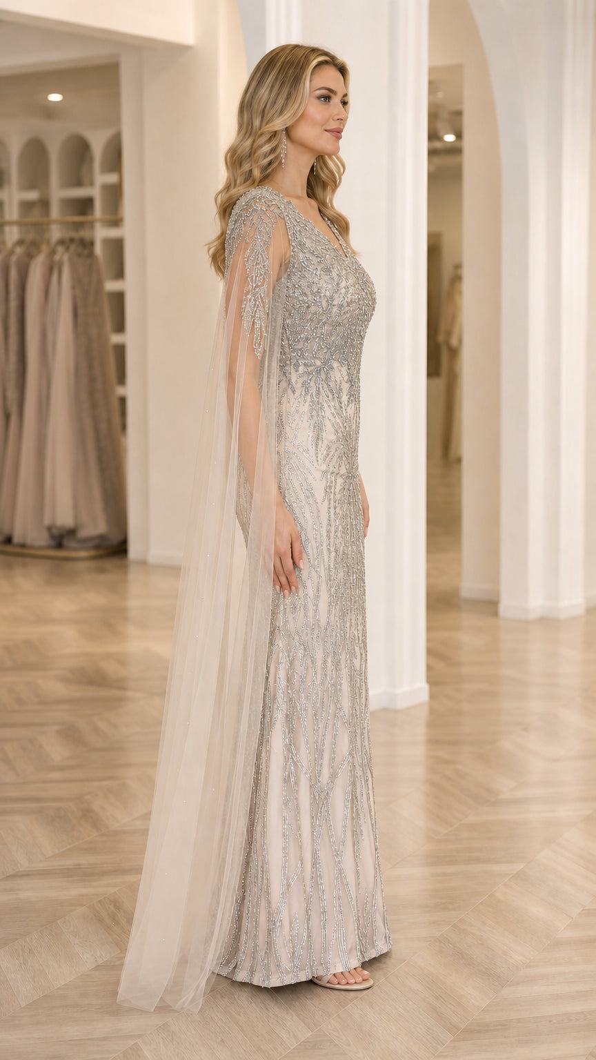 Side profile of Champagne Silver beaded evening dress showing floor-length flowing cape sleeves