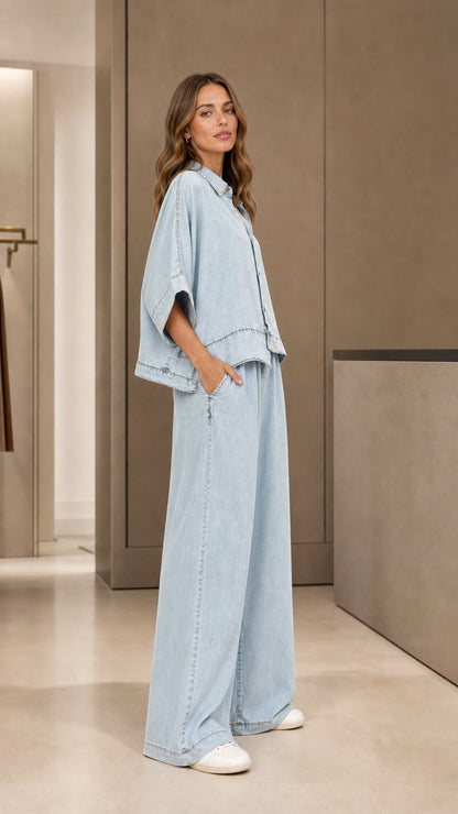 Side angle view of model in light blue matching shirt and wide-leg trousers