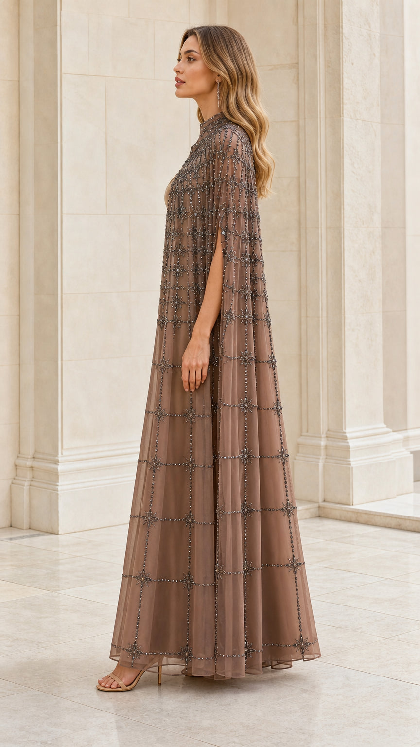 Side profile view of taupe beaded cape gown