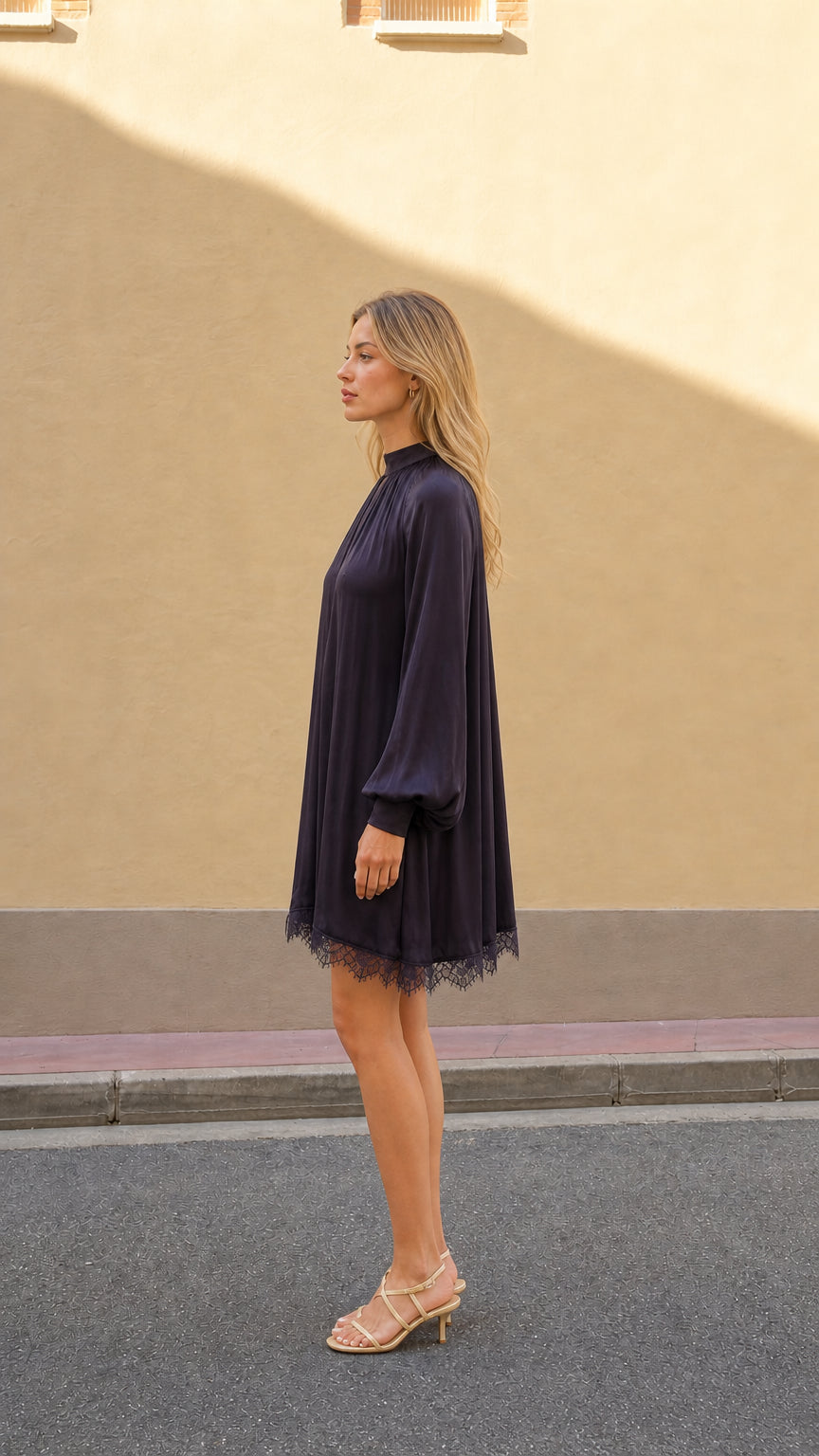 Plum long sleeve mini dress shown from the side