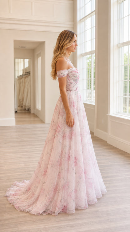 Side profile view of blush pink floral tulle gown with train