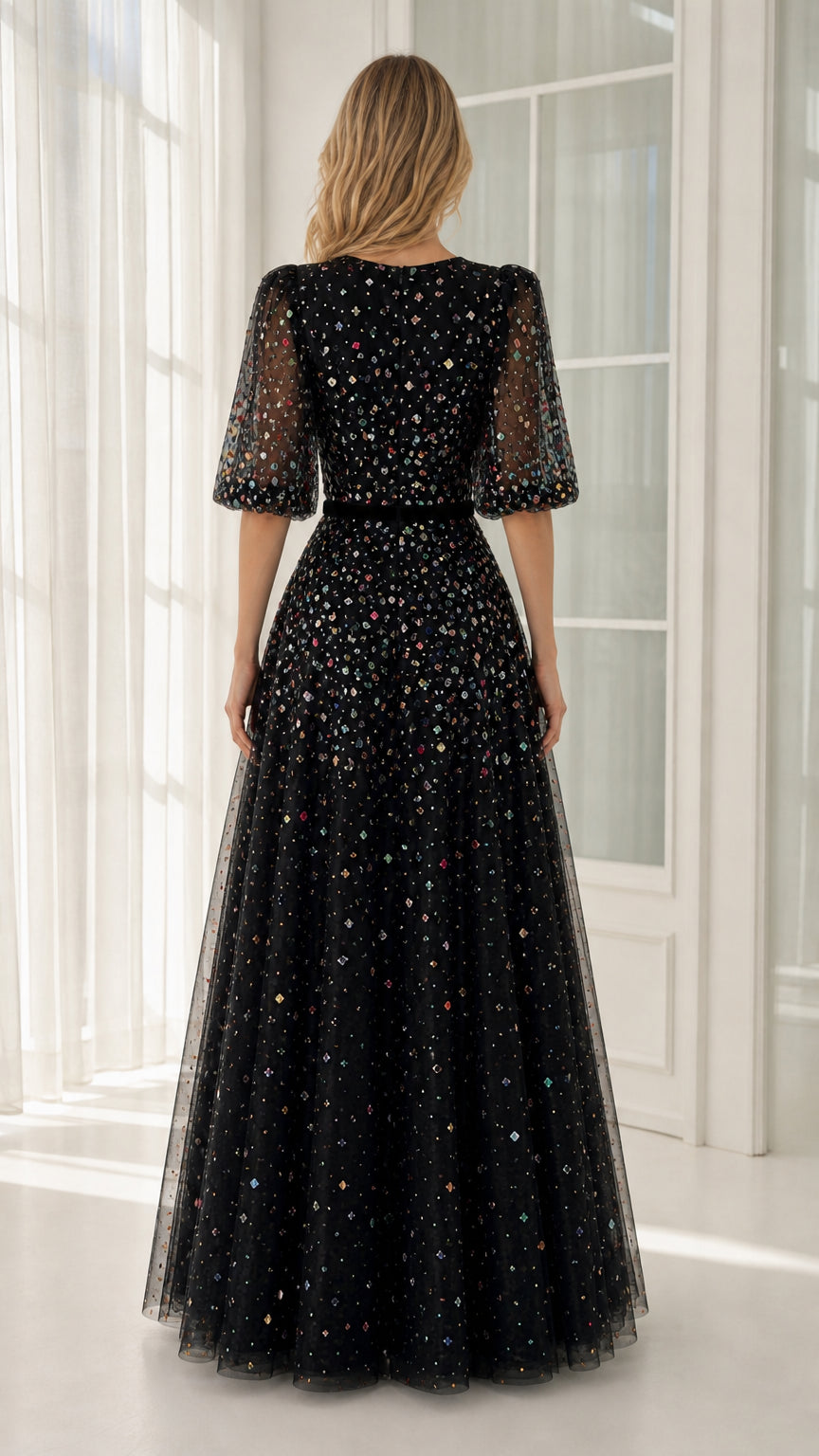 Back view of black tulle evening gown with puff sleeves