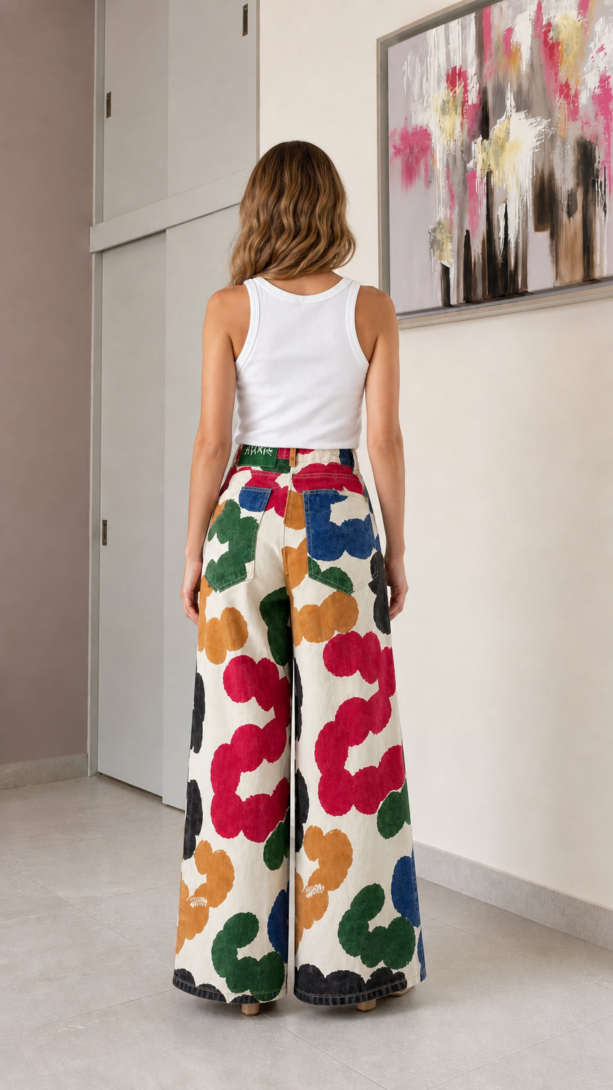 Back view of woman wearing cream floral wide-leg jeans