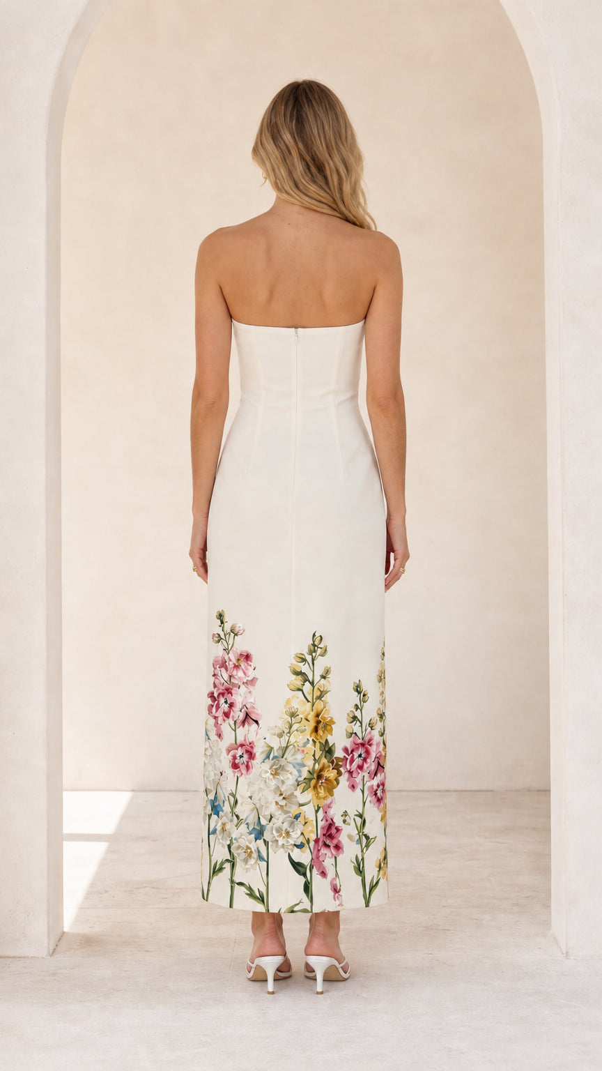 Model wearing white floral strapless midi maxi dress from the back