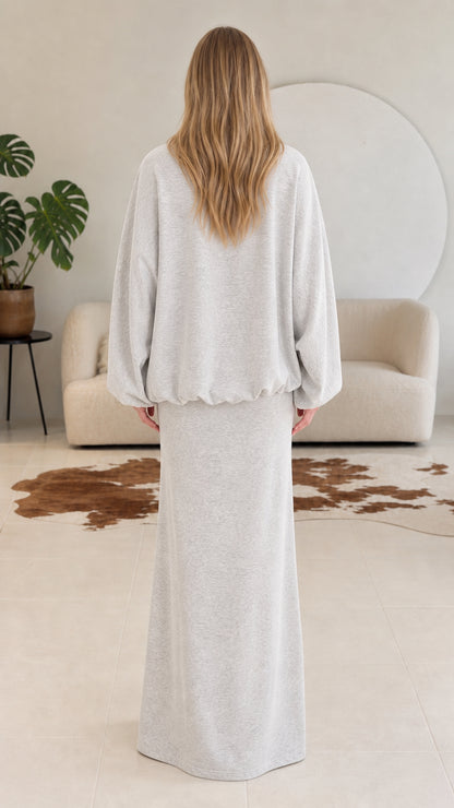 Back view of model wearing heather grey oversized jacket and maxi skirt set