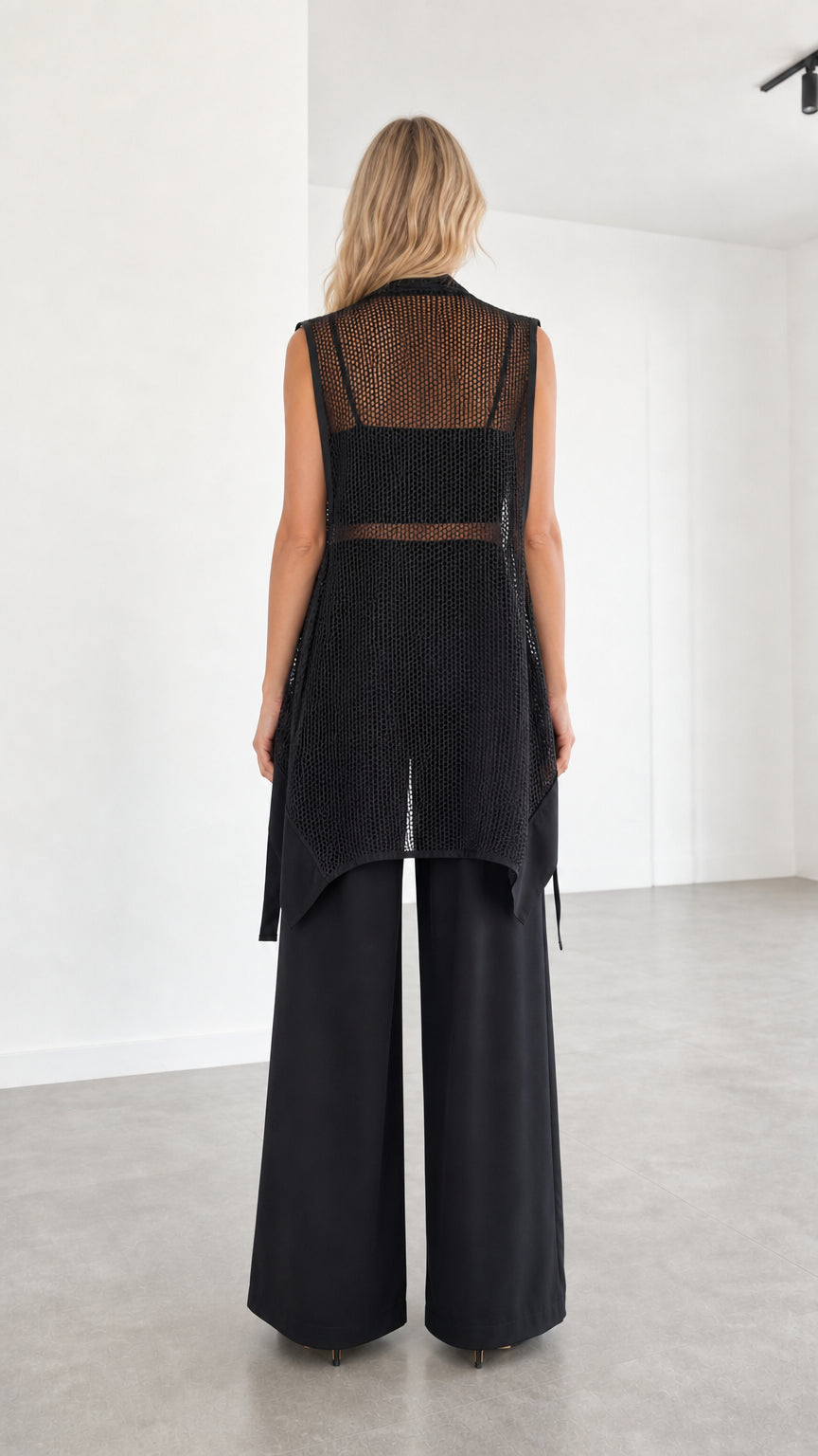 Model wearing black two-piece set back view
