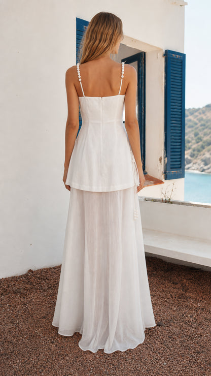 Back view of woman in white layered maxi dress